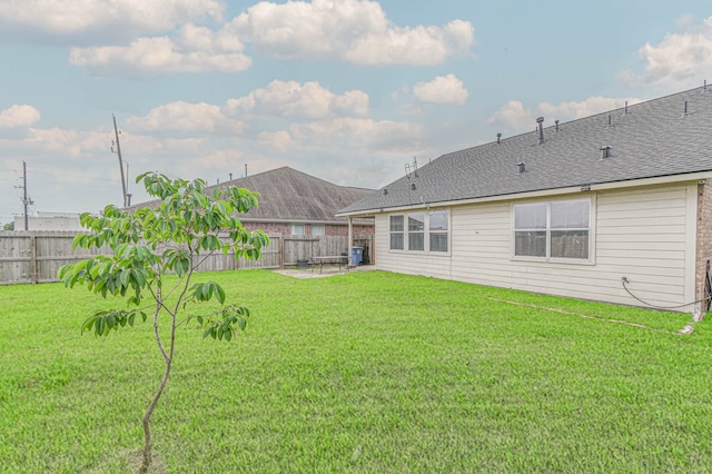 rear view of property featuring a patio and a shingled roof