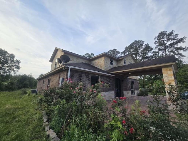 view of side of property with stone siding and brick siding