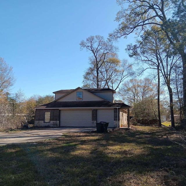 view of home's exterior with a garage, a yard, and concrete driveway