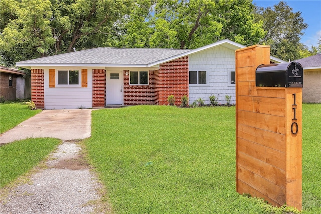 110 Prune St, La Marque, TX 77568 - view of front of property featuring a front lawn, roof with shingles, and driveway
