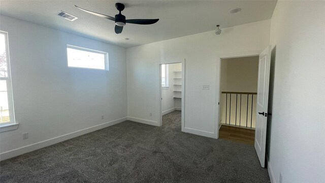 9316 Waller St, Houston, TX 77012 - unfurnished bedroom with carpet floors, a walk in closet, baseboards, and ceiling fan