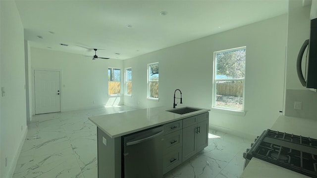 9316 Waller St, Houston, TX 77012 - kitchen with dishwasher, light marble finish floors, a sink, gas range, and ceiling fan