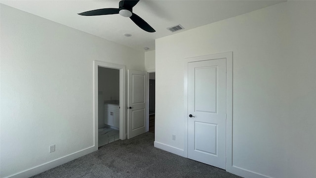 9316 Waller St, Houston, TX 77012 - unfurnished bedroom with dark carpet, ensuite bathroom, baseboards, and ceiling fan