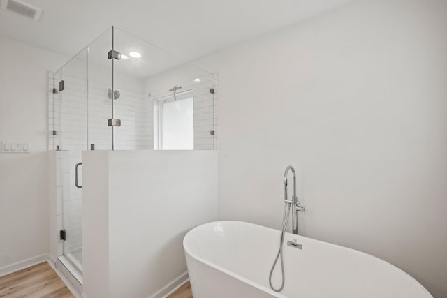 4106 Gardendale Dr, Houston, TX 77092 - full bathroom with a soaking tub, a shower stall, wood finished floors, and baseboards