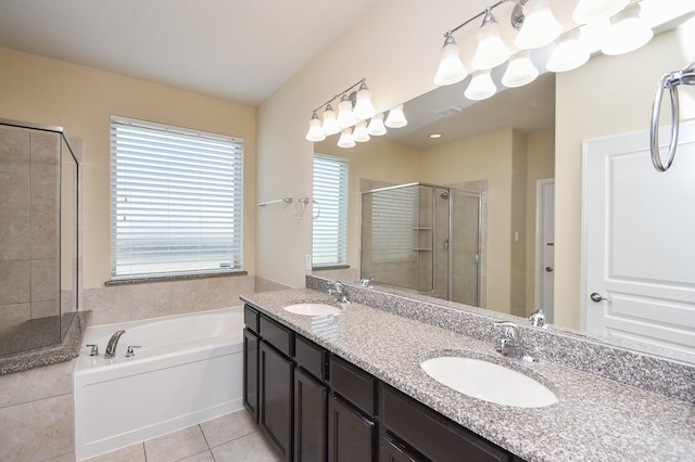 bathroom featuring a stall shower, tile patterned flooring, a garden tub, and double vanity