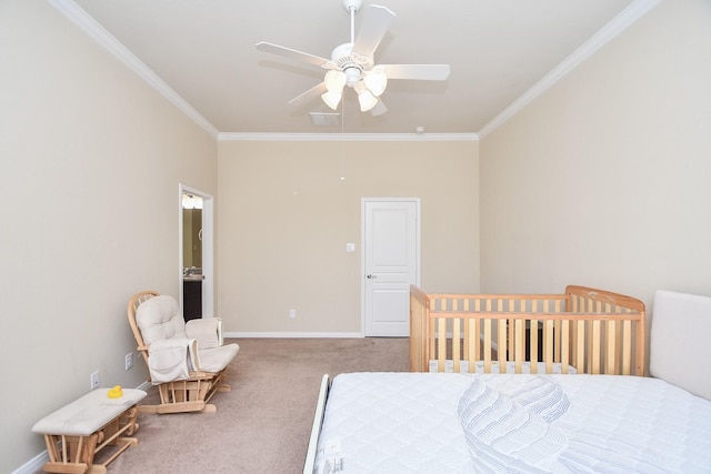 carpeted bedroom featuring ornamental molding, baseboards, and ceiling fan