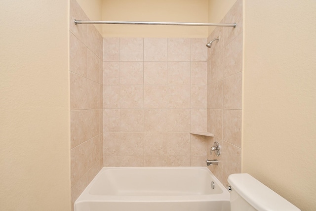 bathroom featuring toilet and  shower combination