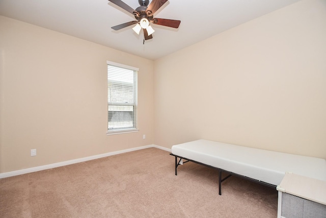 sitting room featuring light colored carpet, baseboards, and ceiling fan