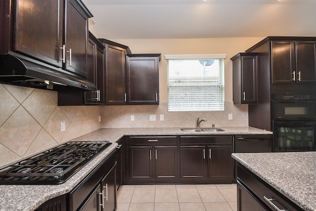 kitchen with black appliances, a sink, under cabinet range hood, dark brown cabinetry, and light tile patterned floors