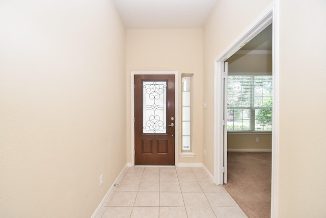 entrance foyer with light tile patterned floors and baseboards