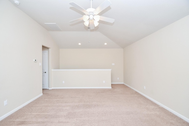 spare room with a ceiling fan, light carpet, recessed lighting, lofted ceiling, and baseboards
