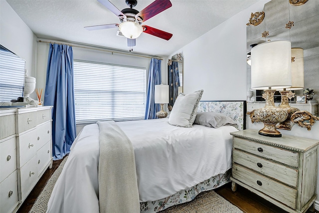 13600 Breton Ridge St Unit 25B, Houston, TX 77070 - bedroom with dark wood-type flooring and a ceiling fan