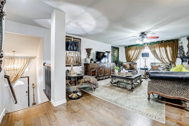 13600 Breton Ridge St Unit 25B, Houston, TX 77070 - living room featuring a chandelier, ceiling fan, and wood finished floors
