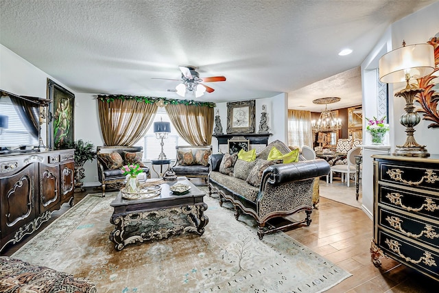 13600 Breton Ridge St Unit 25B, Houston, TX 77070 - living room with a chandelier, plenty of natural light, a textured ceiling, a ceiling fan, and wood finished floors