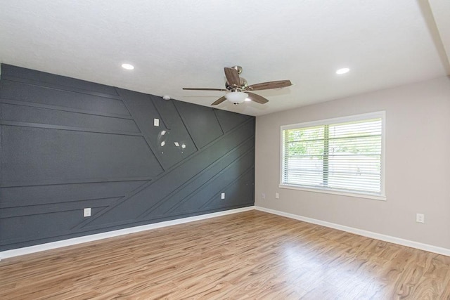unfurnished room featuring light wood-style floors, a ceiling fan, baseboards, and recessed lighting