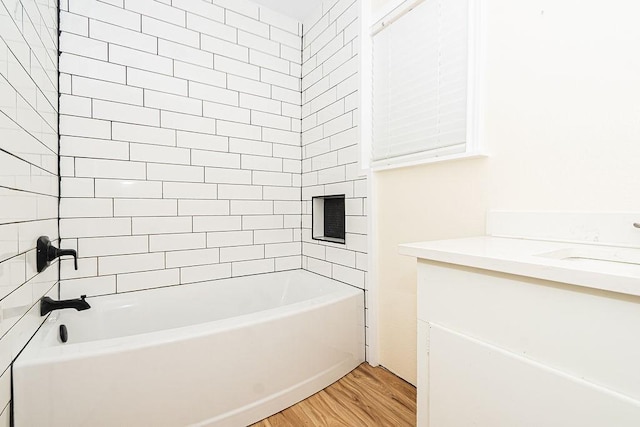 full bath featuring wood finished floors, tub / shower combination, and vanity