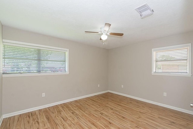 unfurnished room featuring light wood-type flooring, ceiling fan, and baseboards