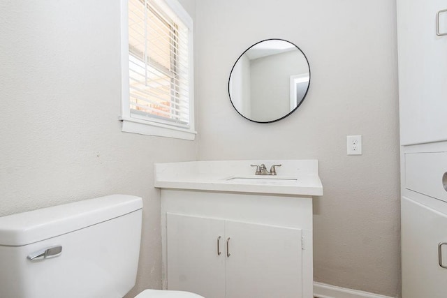 half bath featuring toilet and vanity
