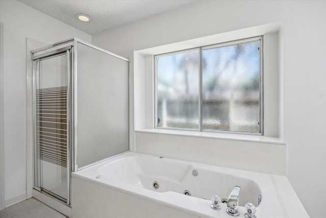 12514 Wealdstone Dr, Tomball, TX 77377 - bathroom featuring a jetted tub, a shower stall, and tile patterned flooring