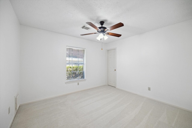 12514 Wealdstone Dr, Tomball, TX 77377 - spare room featuring ceiling fan, light carpet, a textured ceiling, and baseboards