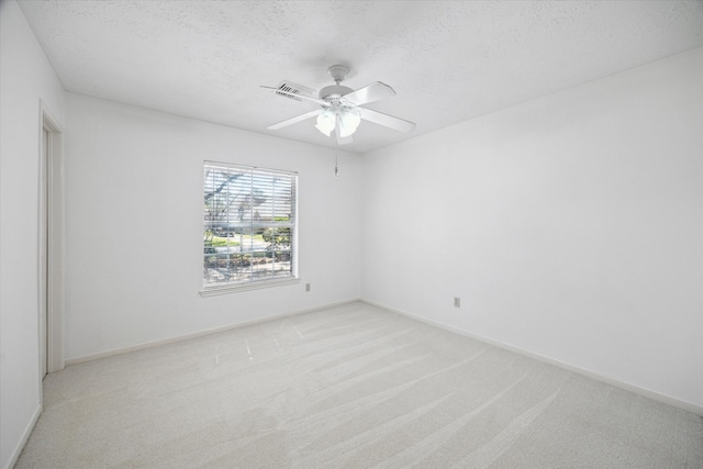 12514 Wealdstone Dr, Tomball, TX 77377 - empty room with light carpet, ceiling fan, a textured ceiling, and baseboards