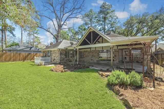 12514 Wealdstone Dr, Tomball, TX 77377 - rear view of property featuring a chimney, a patio, brick siding, and a shingled roof