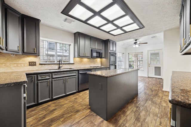12514 Wealdstone Dr, Tomball, TX 77377 - kitchen with appliances with stainless steel finishes, a sink, a ceiling fan, a center island, and plenty of natural light