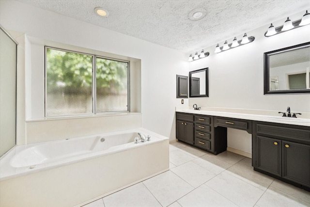 12514 Wealdstone Dr, Tomball, TX 77377 - bathroom featuring a bath, tile patterned floors, double vanity, and a textured ceiling