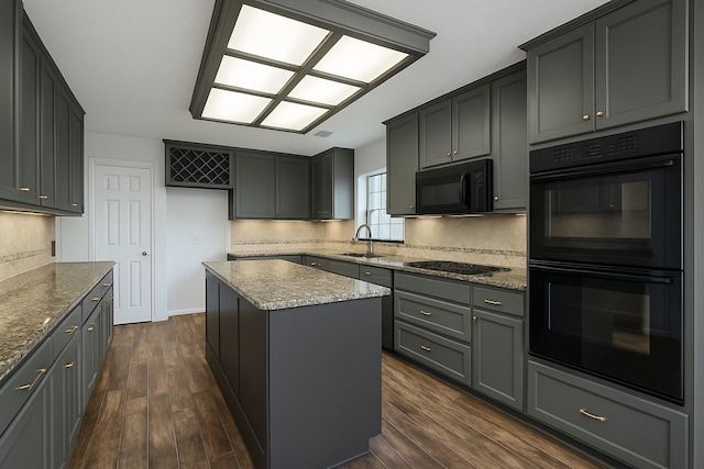12514 Wealdstone Dr, Tomball, TX 77377 - kitchen featuring black appliances, a sink, a center island, and dark wood-style flooring