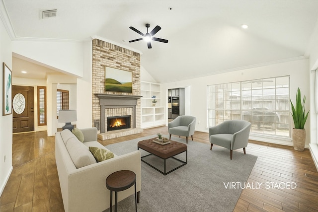 12514 Wealdstone Dr, Tomball, TX 77377 - living area with ceiling fan, high vaulted ceiling, hardwood / wood-style floors, a brick fireplace, and built in features