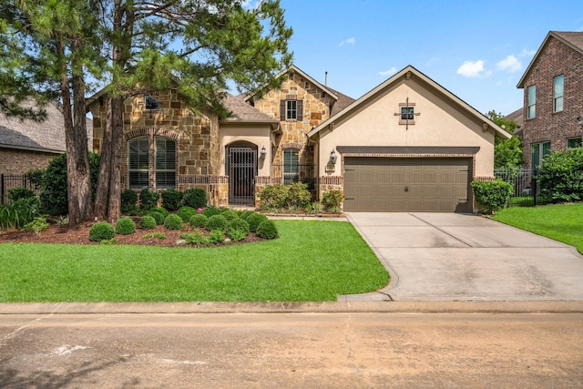 view of front of house with stone siding, stucco siding, driveway, and a garage