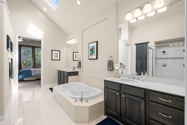 bathroom with a shower stall, high vaulted ceiling, a garden tub, tile patterned floors, and baseboards