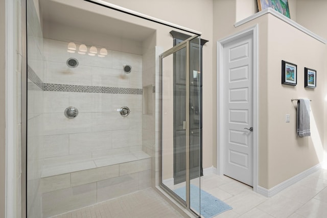 full bathroom featuring a shower stall, tile patterned flooring, and baseboards