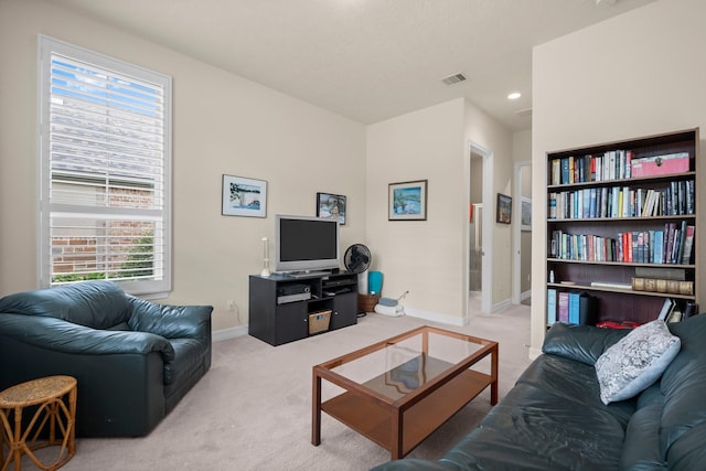 carpeted living area with baseboards, plenty of natural light, and recessed lighting