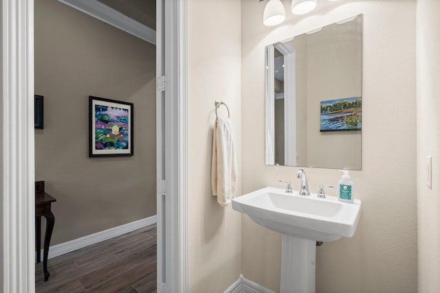 bathroom featuring wood finished floors and baseboards