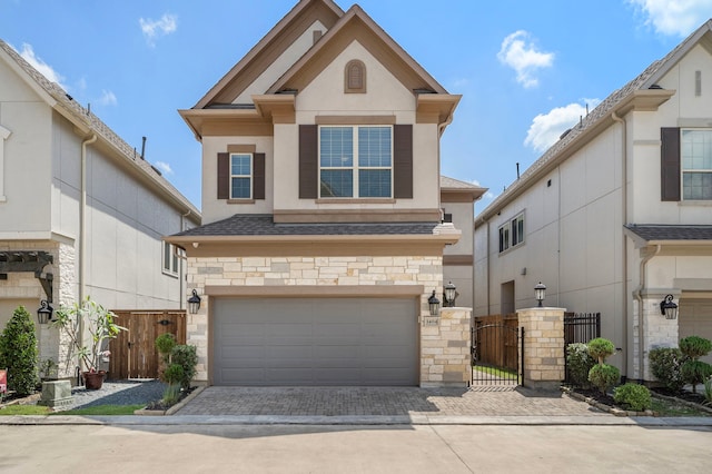 1404 Arkley Way, Houston, TX 77055 - view of front of property with a garage, stone siding, stucco siding, decorative driveway, and a gate