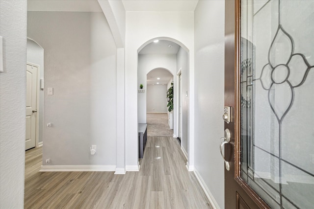 21022 Solstice Point Dr, Hockley, TX 77447 - entrance foyer with light wood-style flooring, baseboards, and arched walkways