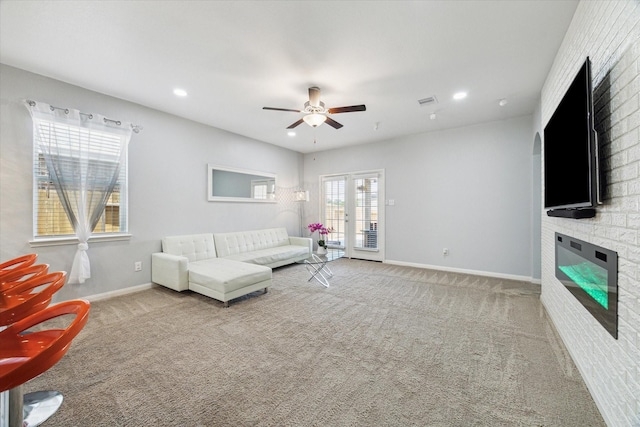 21022 Solstice Point Dr, Hockley, TX 77447 - carpeted living room featuring a large fireplace, ceiling fan, french doors, baseboards, and recessed lighting