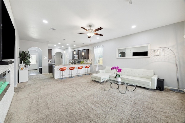 21022 Solstice Point Dr, Hockley, TX 77447 - living room with arched walkways, a ceiling fan, light colored carpet, and recessed lighting