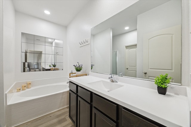 21022 Solstice Point Dr, Hockley, TX 77447 - bathroom featuring wood finished floors, a bath, vanity, and recessed lighting