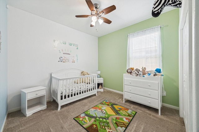 21022 Solstice Point Dr, Hockley, TX 77447 - carpeted bedroom featuring a nursery area, baseboards, and ceiling fan