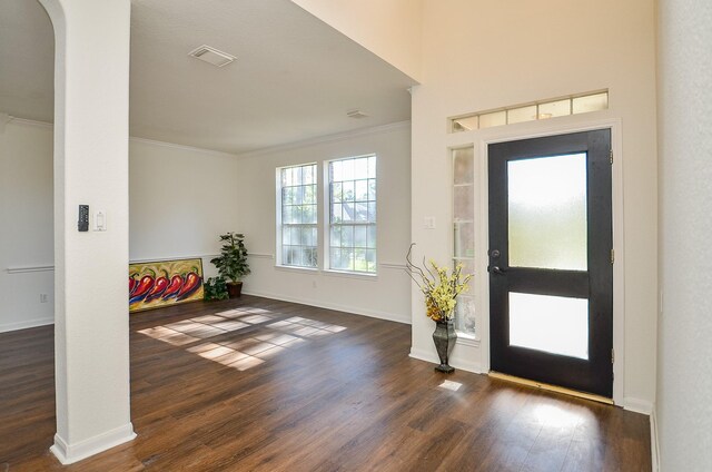 18106 Rileybrook Cir, Houston, TX 77094 - foyer entrance featuring ornamental molding, dark wood finished floors, baseboards, and arched walkways