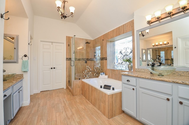 18106 Rileybrook Cir, Houston, TX 77094 - full bath with a shower stall, a garden tub, a chandelier, vaulted ceiling, and wood finished floors