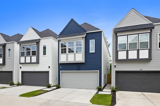 322 Neyland St, Houston, TX 77022 - view of front facade with a garage, concrete driveway, and a shingled roof