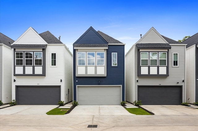 322 Neyland St, Houston, TX 77022 - modern home featuring a garage, driveway, and a shingled roof