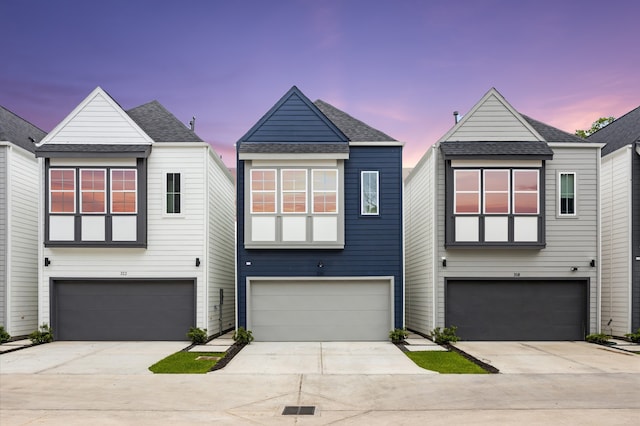 322 Neyland St, Houston, TX 77022 - contemporary home featuring an attached garage, driveway, and roof with shingles