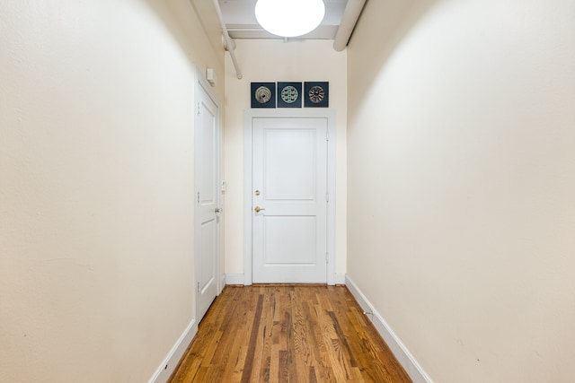 1120 Texas St Unit 7D, Houston, TX 77002 - doorway with wood finished floors and baseboards