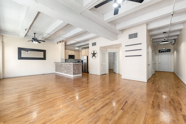 1120 Texas St Unit 7D, Houston, TX 77002 - unfurnished living room with a ceiling fan, beam ceiling, baseboards, and light wood finished floors
