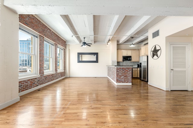 1120 Texas St Unit 7D, Houston, TX 77002 - unfurnished living room with brick wall, light wood-type flooring, beamed ceiling, baseboards, and ceiling fan