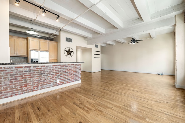 1120 Texas St Unit 7D, Houston, TX 77002 - unfurnished living room with baseboards, beam ceiling, light wood finished floors, a ceiling fan, and rail lighting